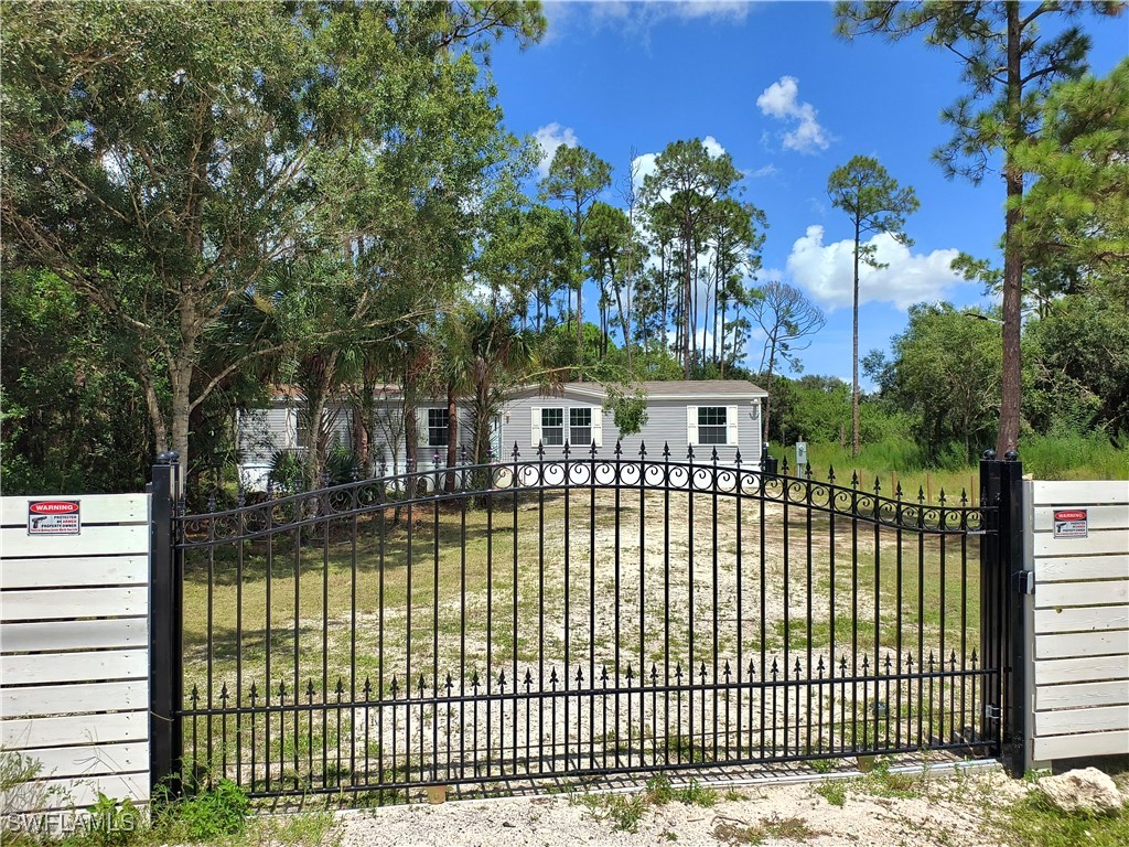 a view of a house with a iron fence