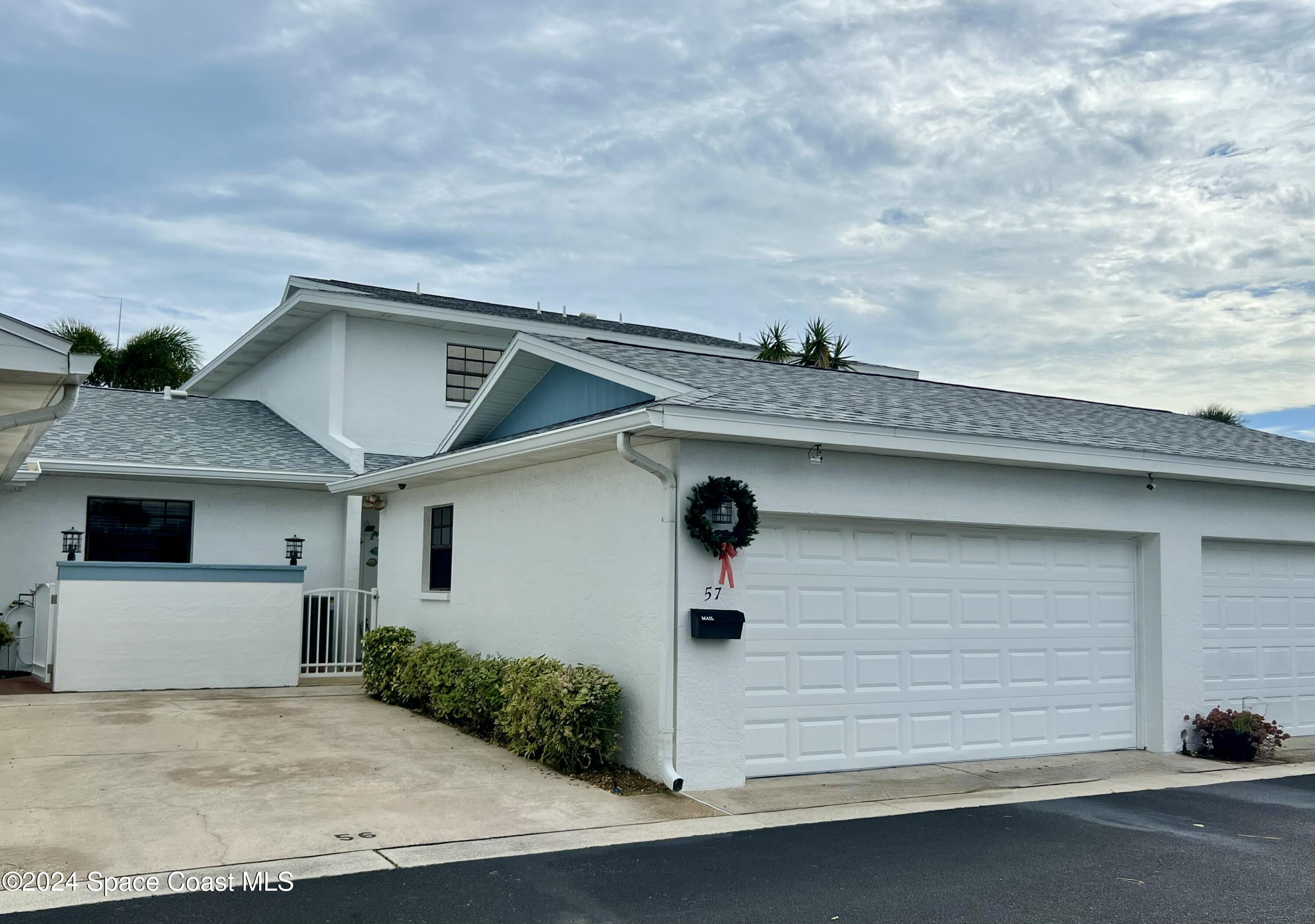 a front view of a house with garage