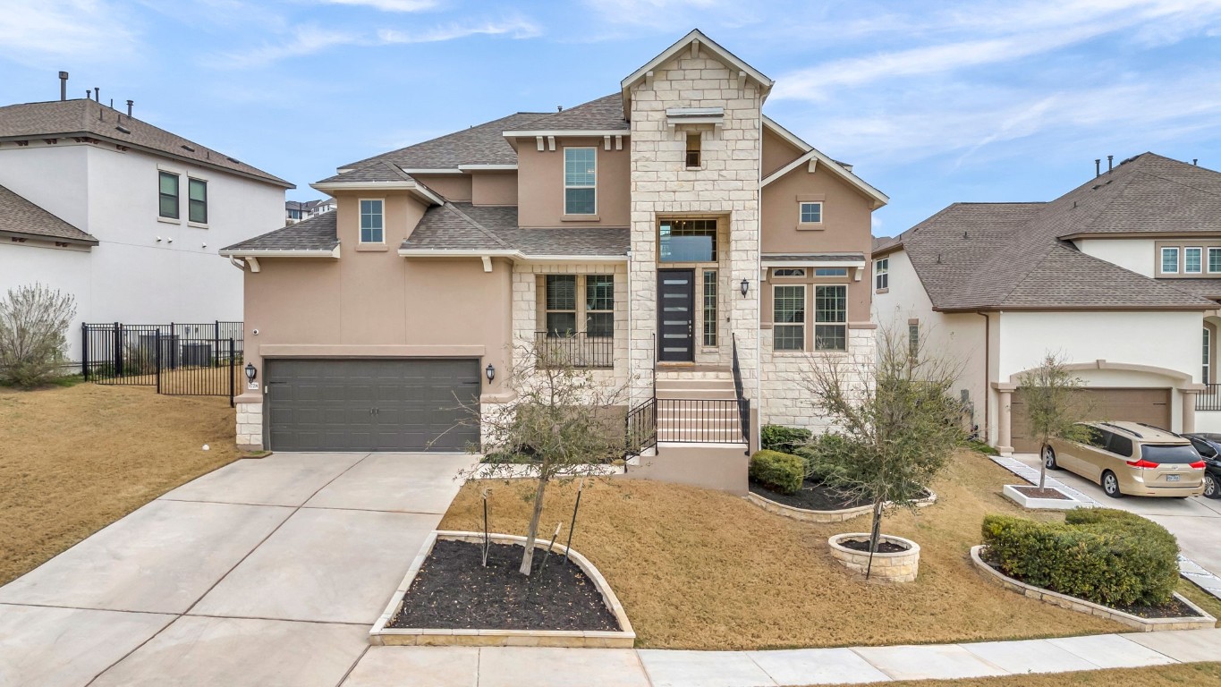 a front view of a house with a yard and garage