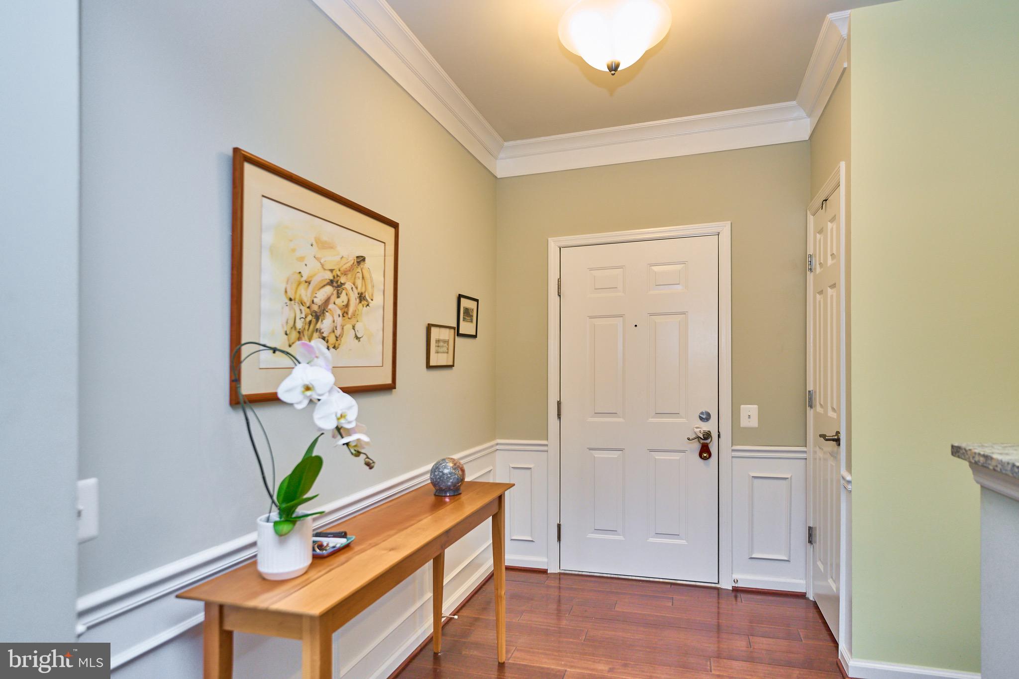 a view of an entryway with wooden floor