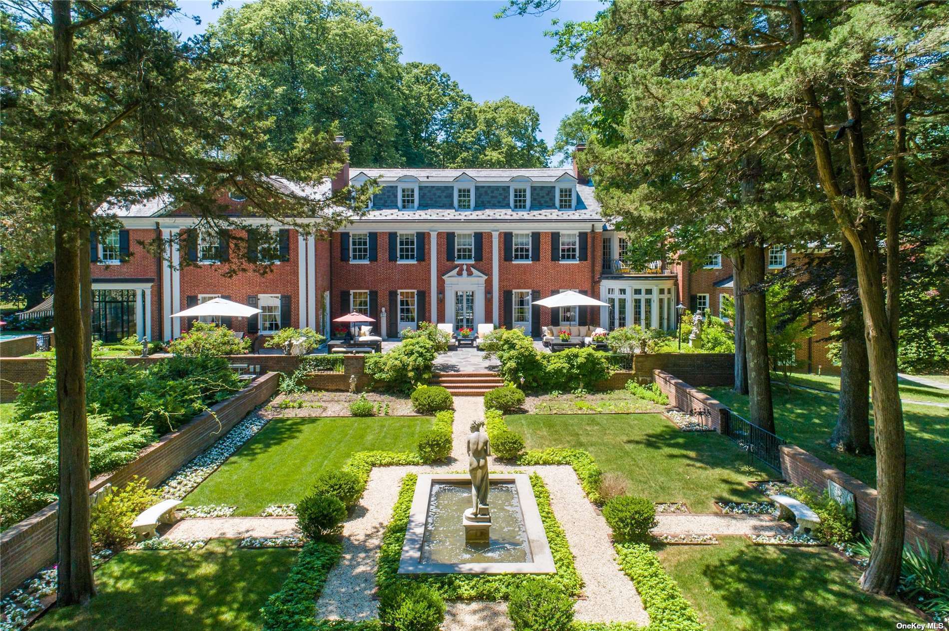 a view of a house with swimming pool and garden