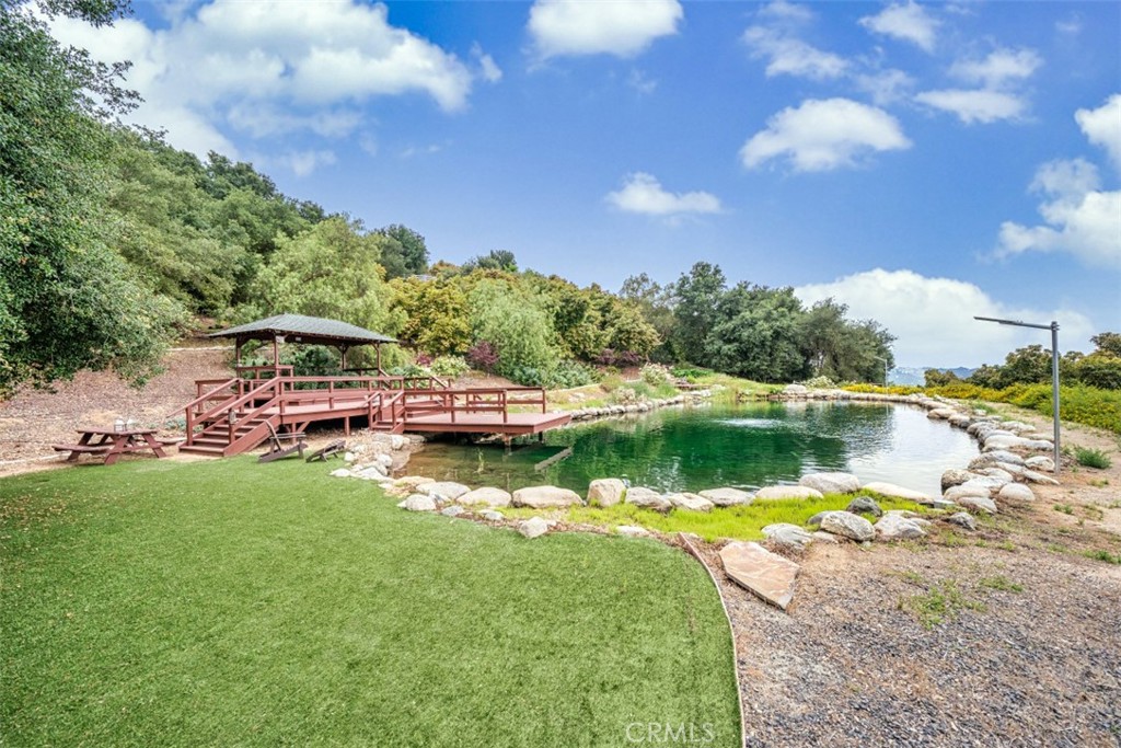 a swimming pool with trees in the background