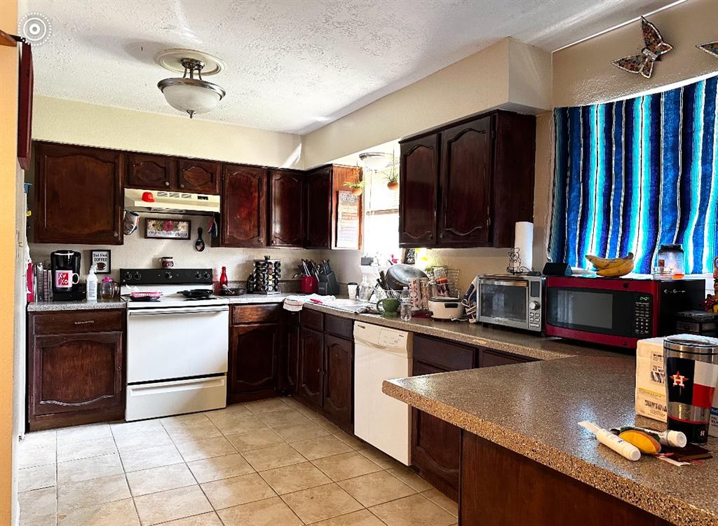 a kitchen with stainless steel appliances granite countertop a stove refrigerator and a sink