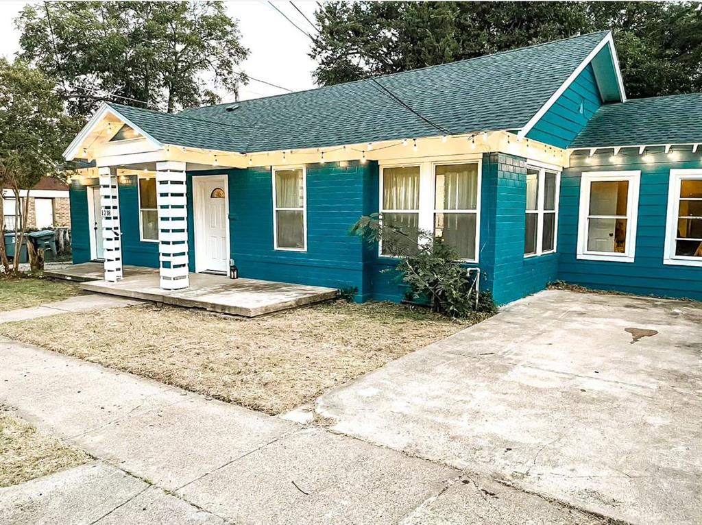 a front view of a house with a yard in front of it