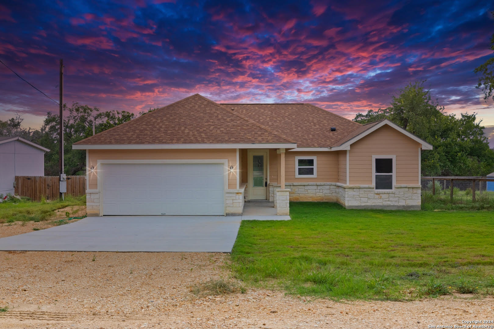 a front view of a house with a garden and yard