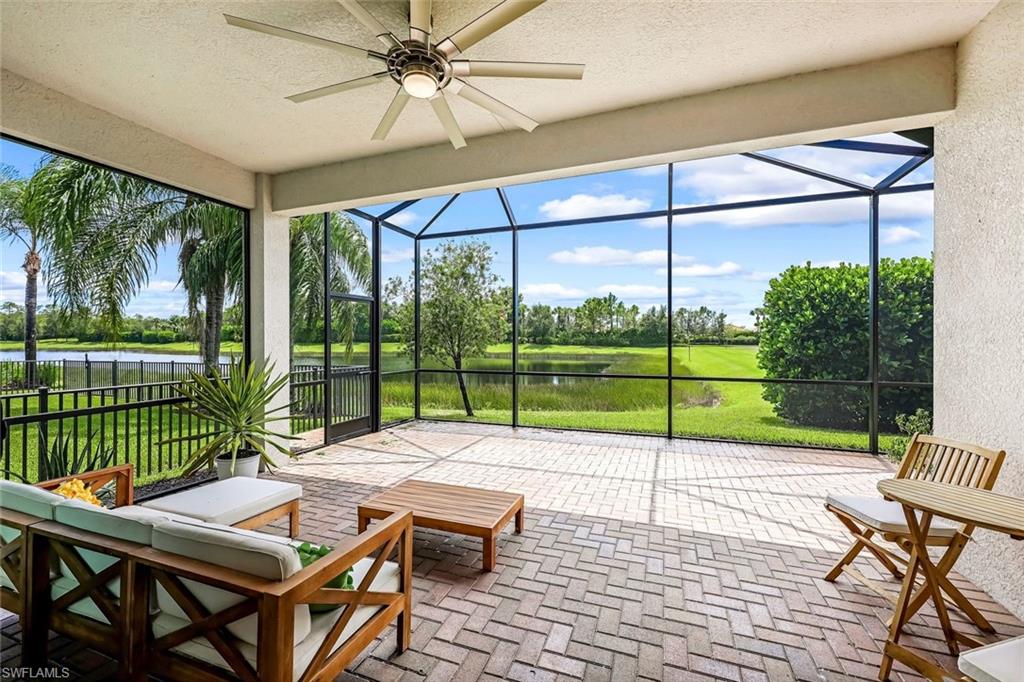 a view of a patio with a table chairs and a backyard