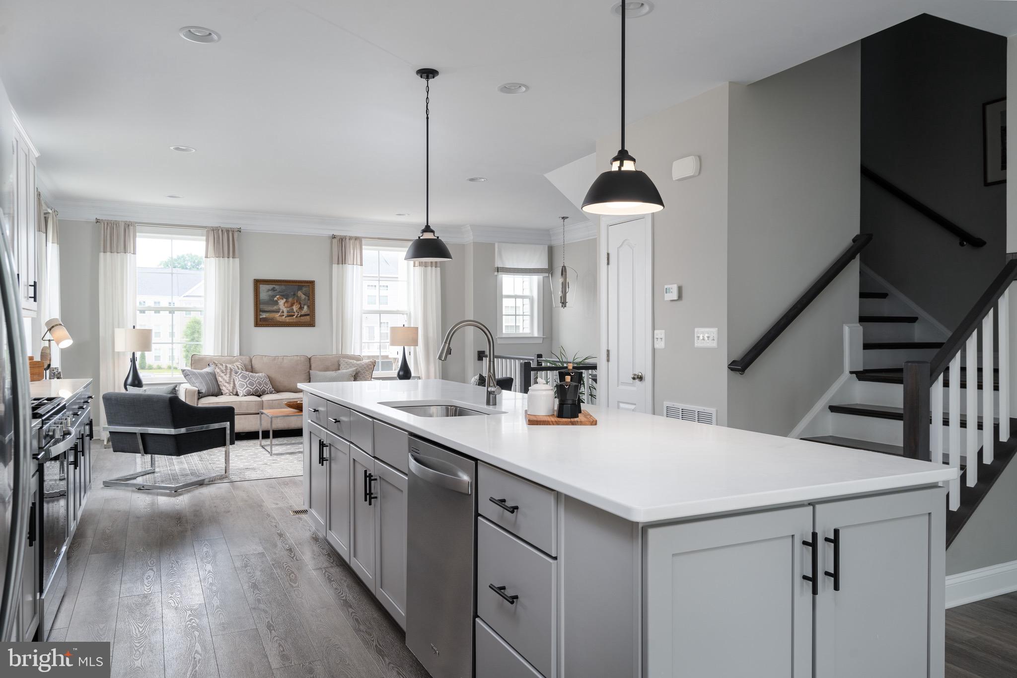 a kitchen with sink stove and cabinets