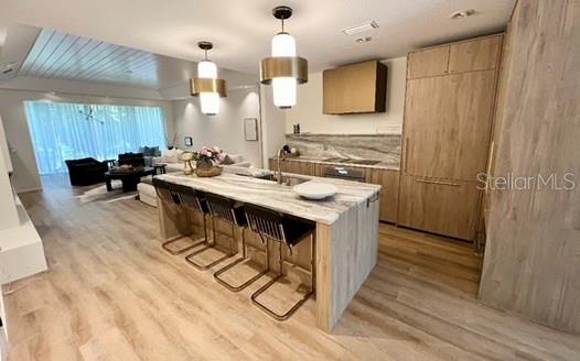 a kitchen with a sink appliances and cabinets