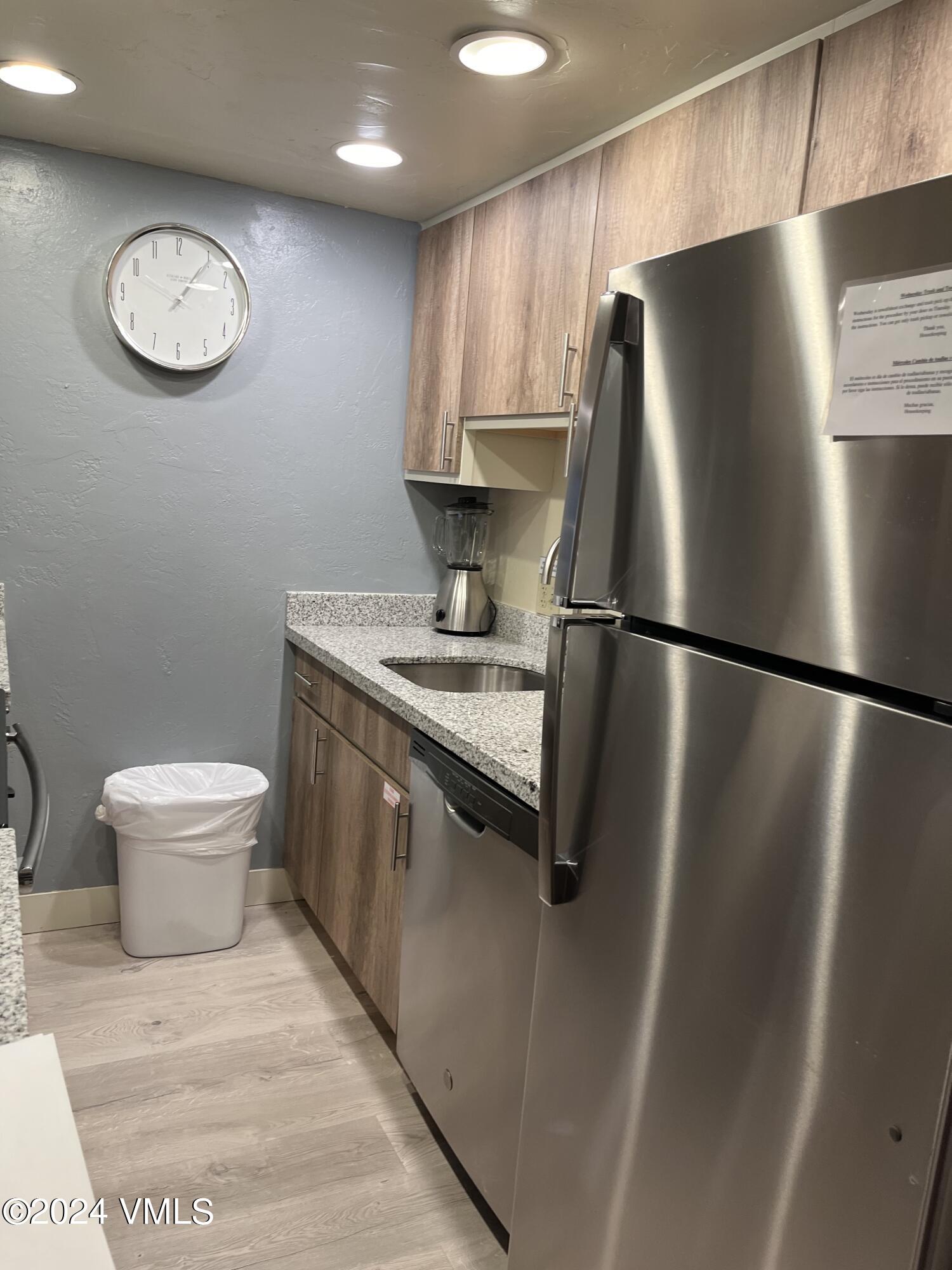 a kitchen with stainless steel appliances a refrigerator and a sink