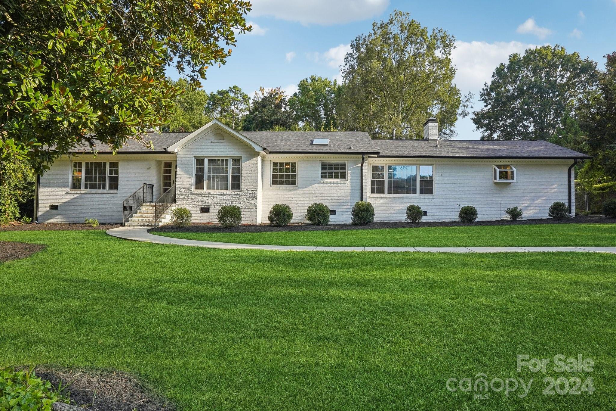 a front view of house with yard and green space