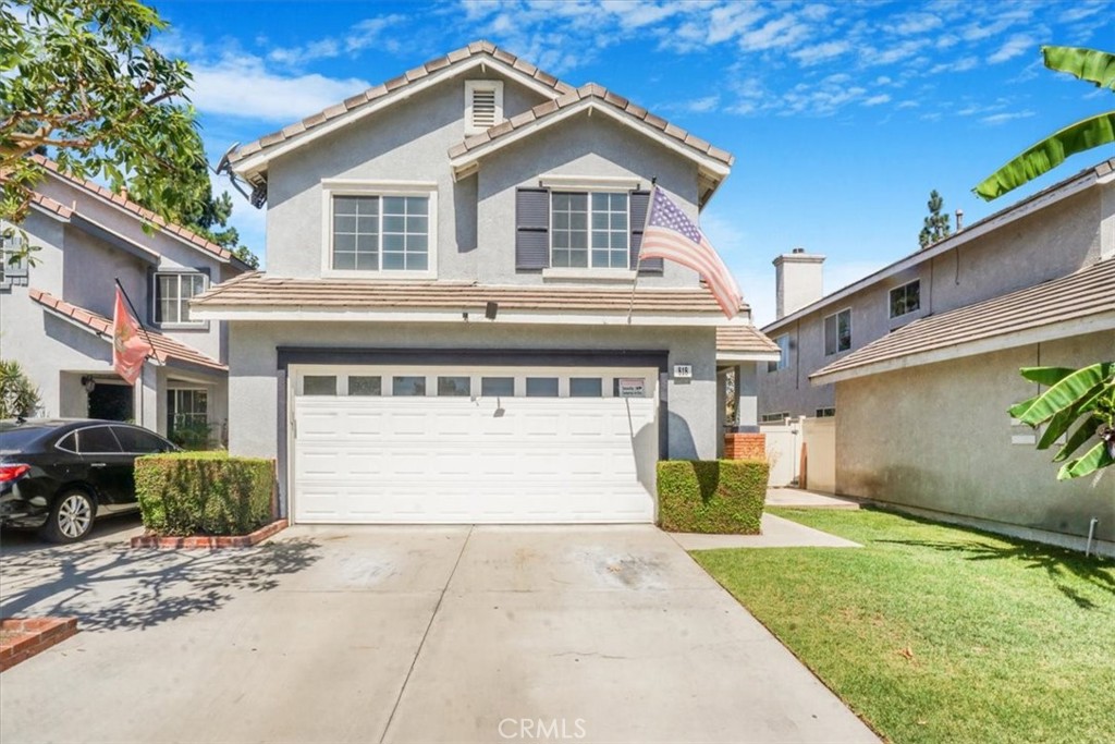 a front view of a house with a yard and garage