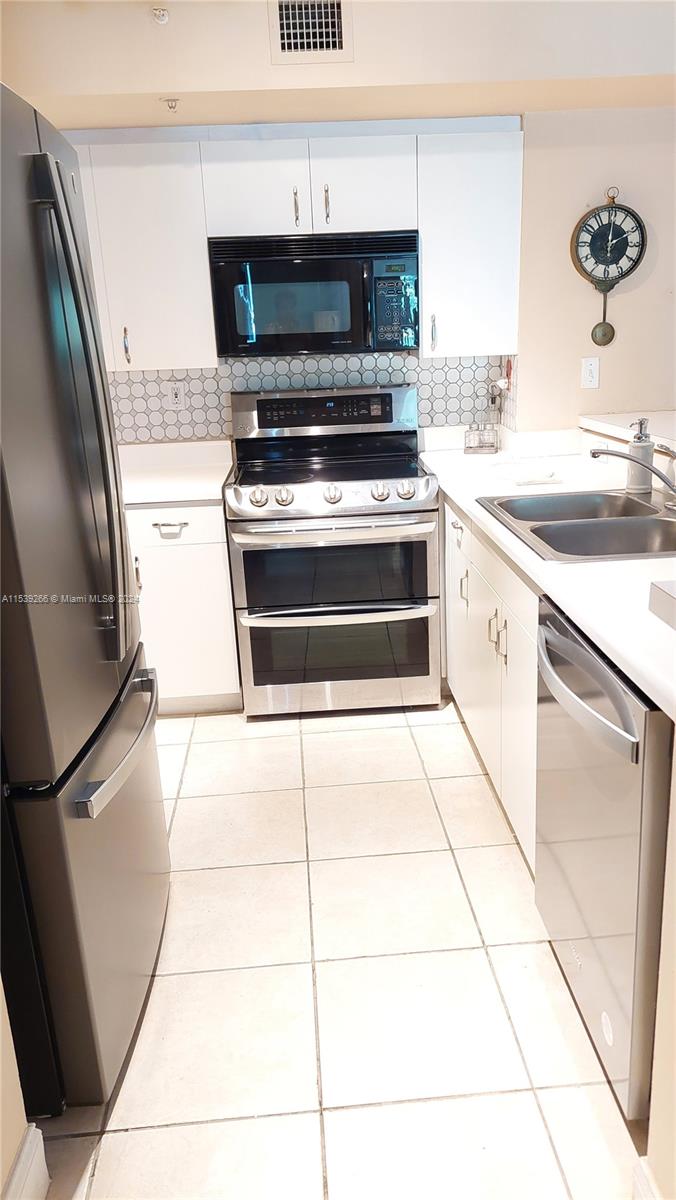 a kitchen with a stove top oven and a sink