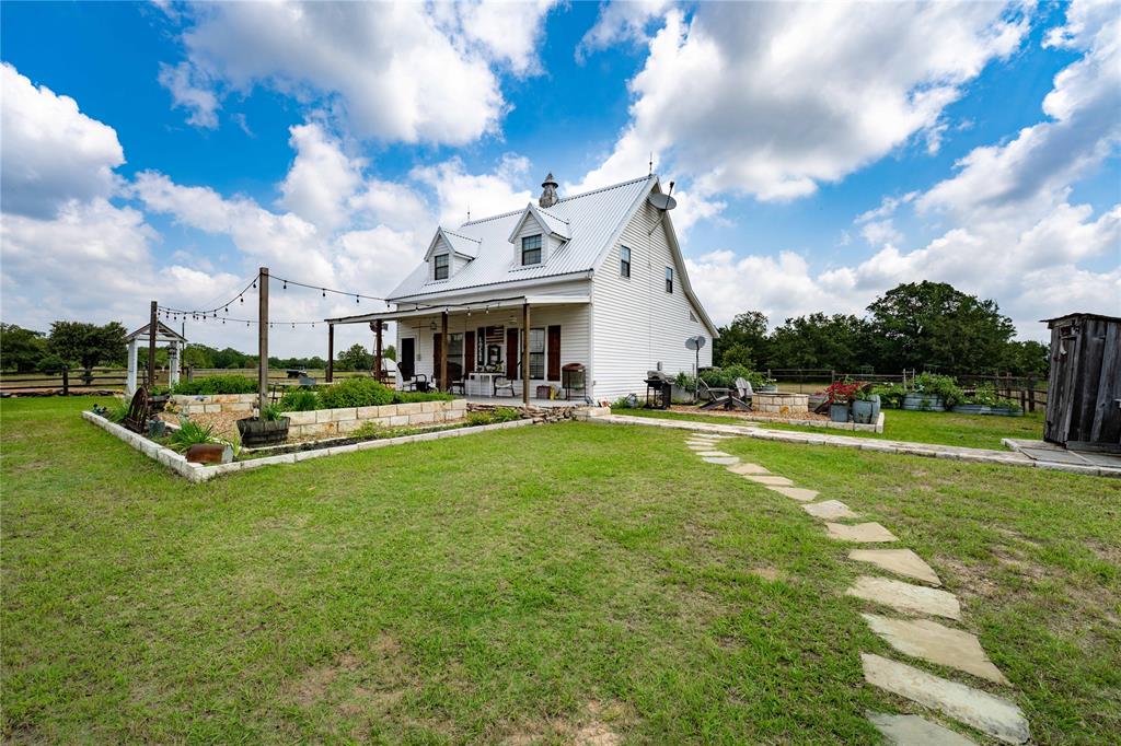 a view of an house with swimming pool and yard