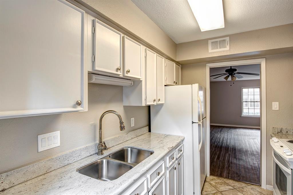 a kitchen with a refrigerator and a sink