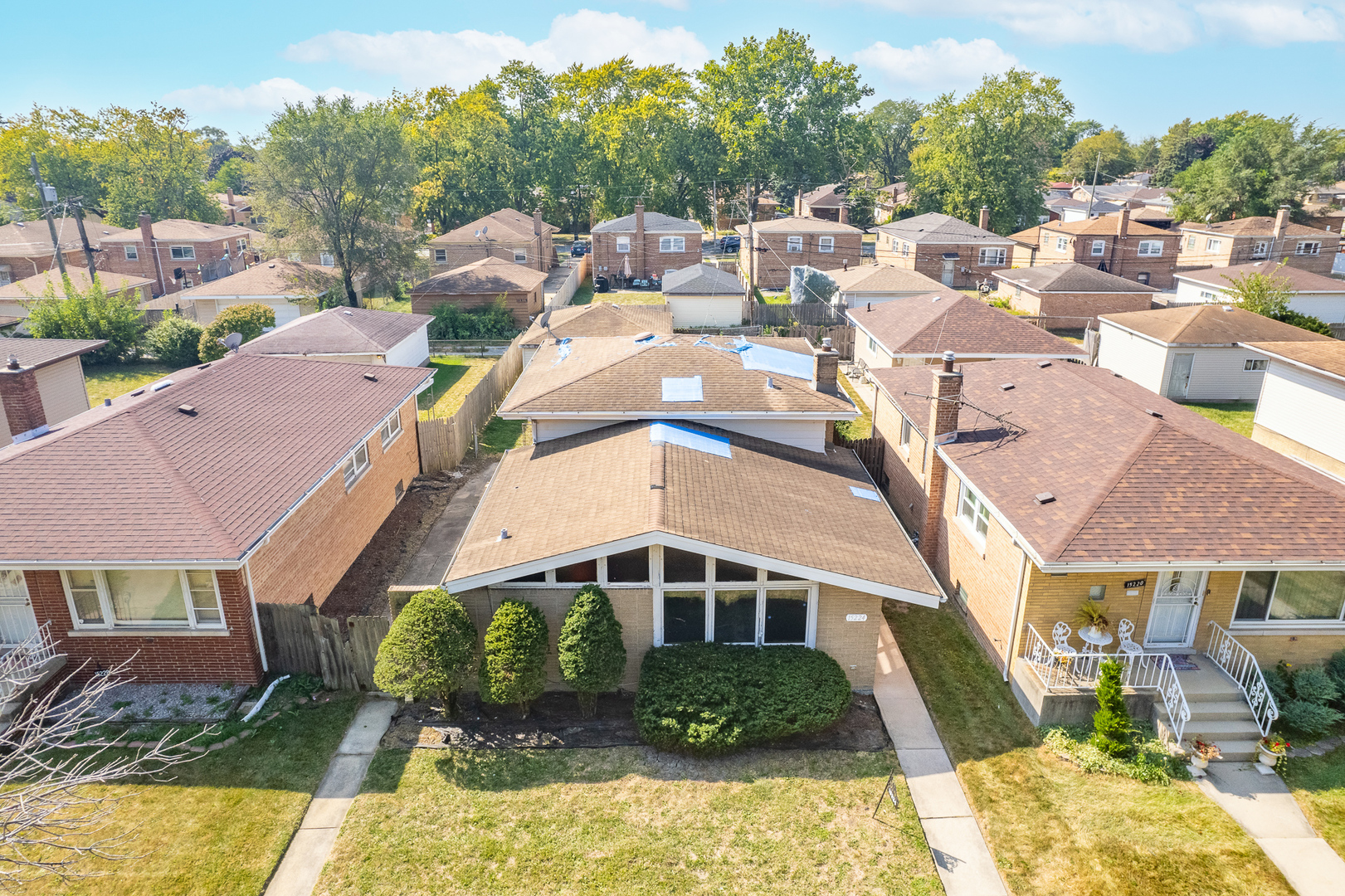 an aerial view of a house with a yard