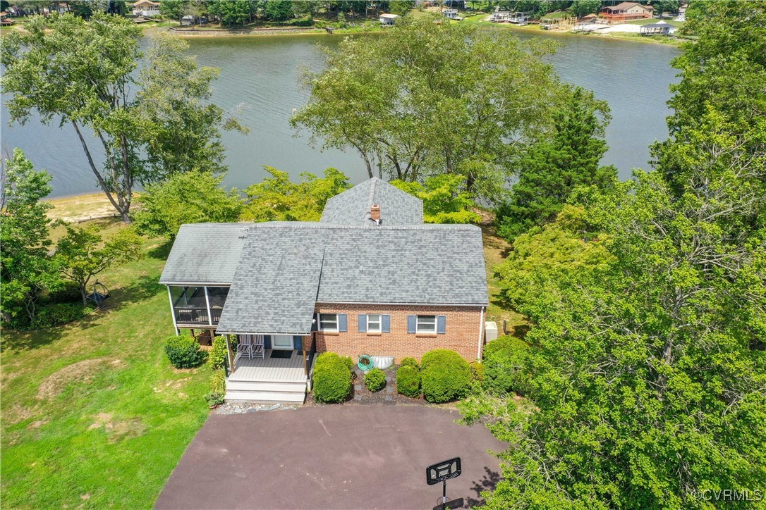 a aerial view of a house with a yard and a large tree