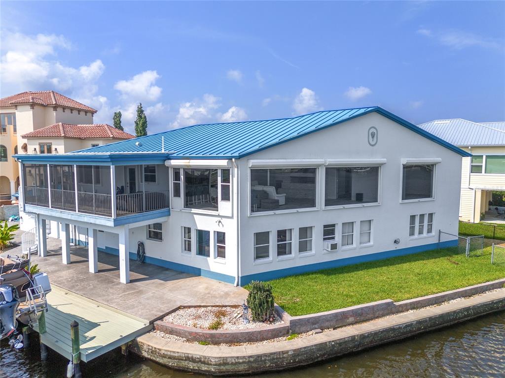 a view of a house with a swimming pool and sitting area