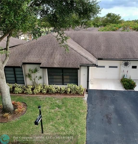 a aerial view of a house with a yard and garage