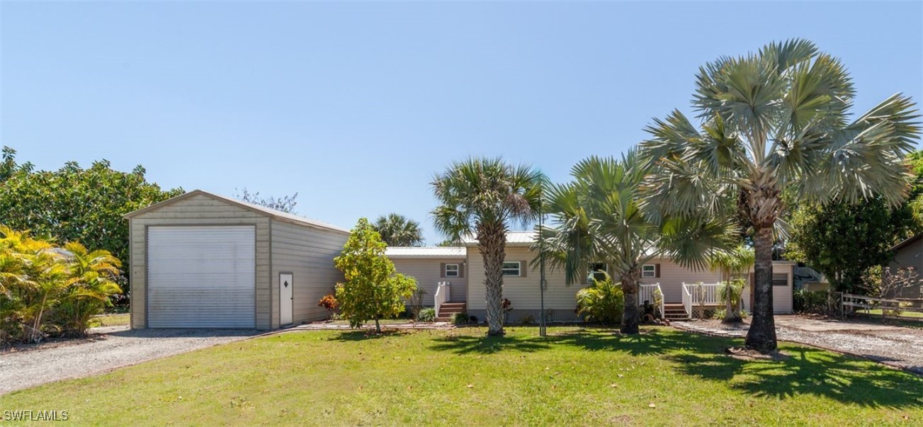 a backyard of a house with yard and tree