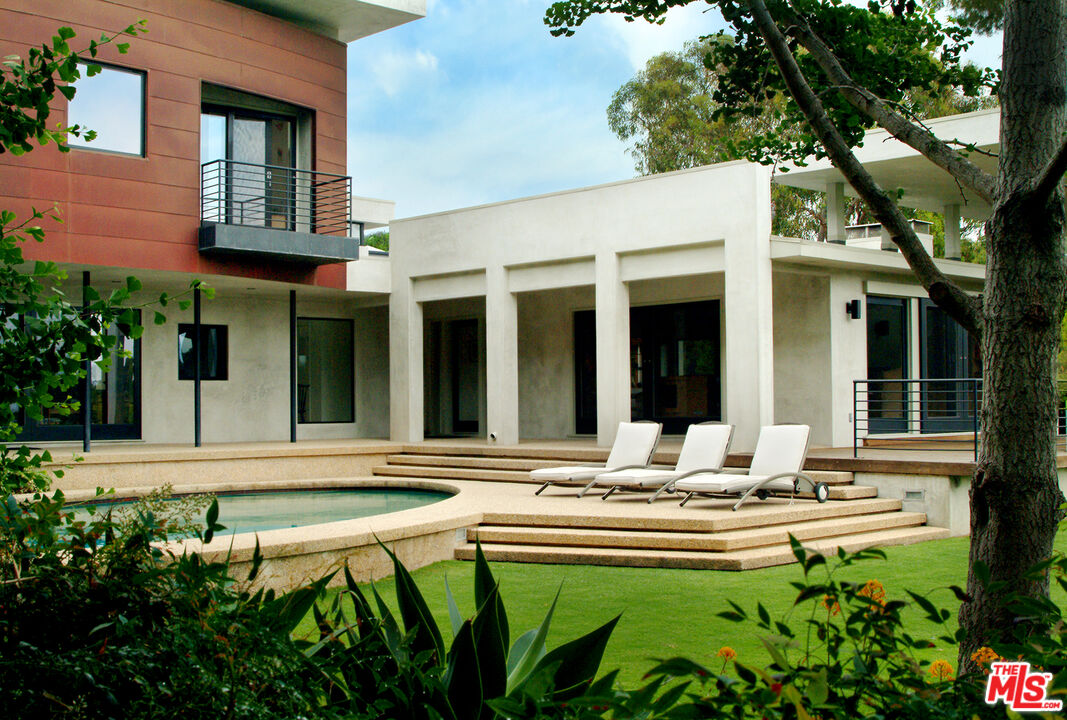 a swimming pool with outdoor seating and yard