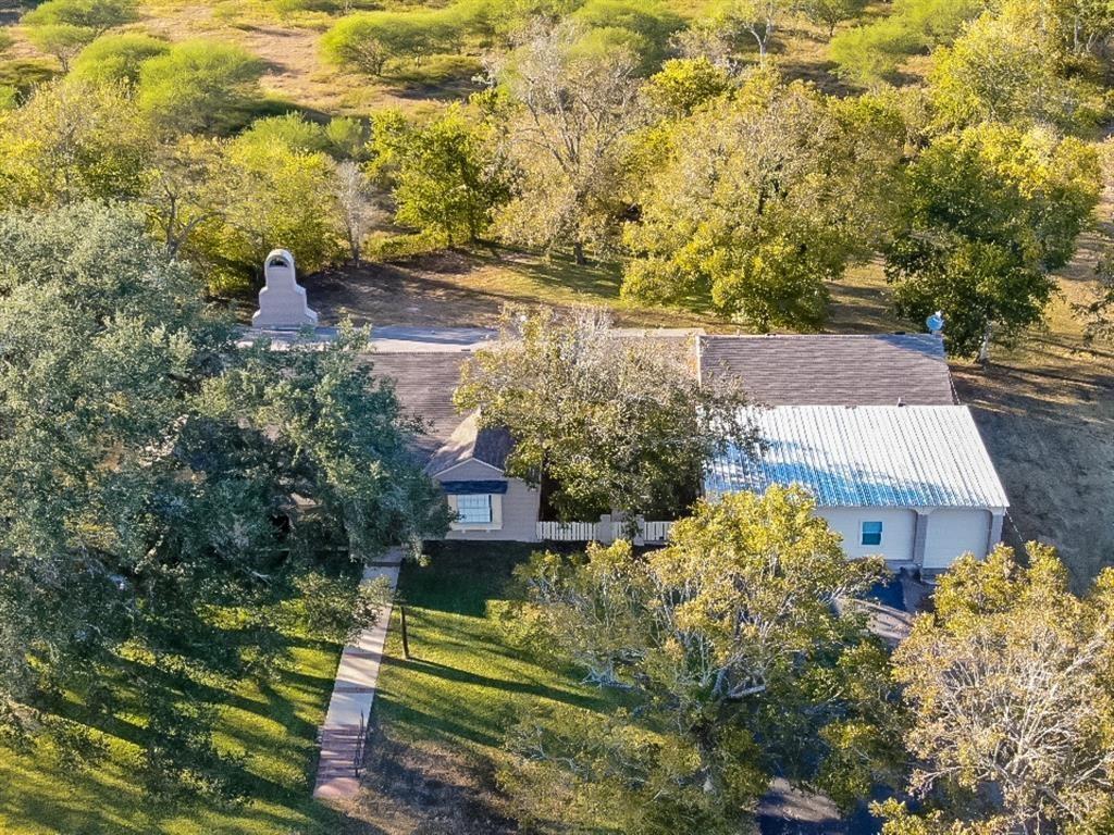 an aerial view of residential houses with yard