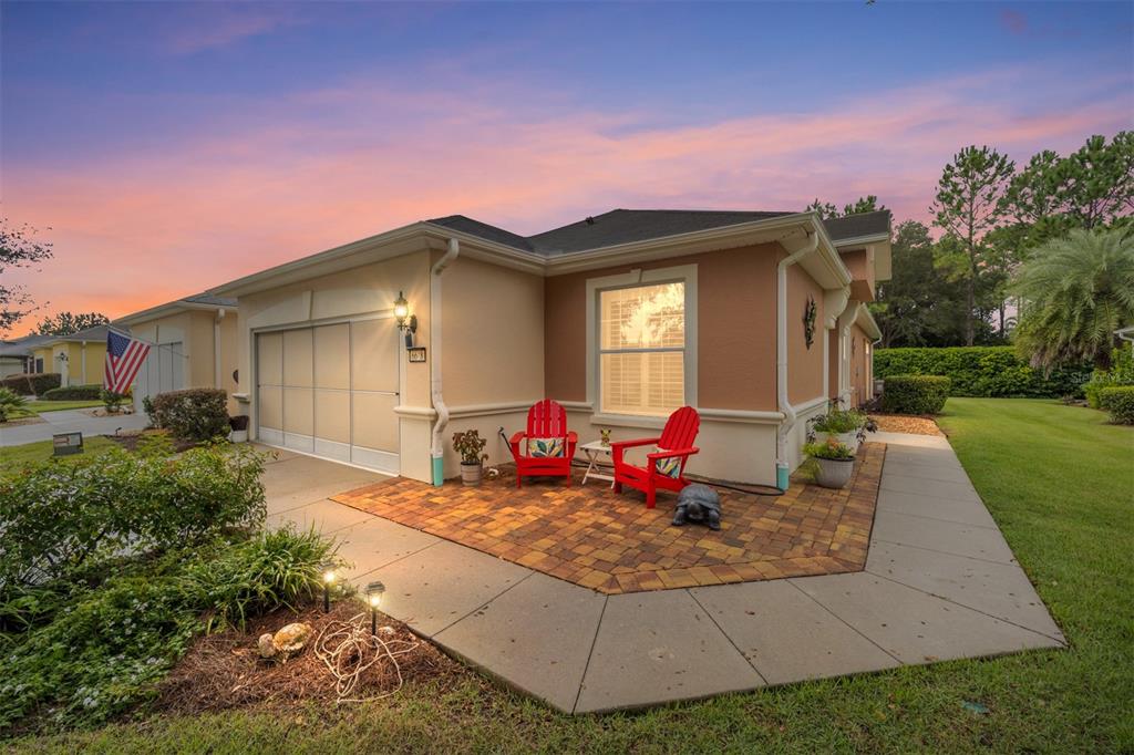 a view of a house with a yard fire pit and a yard