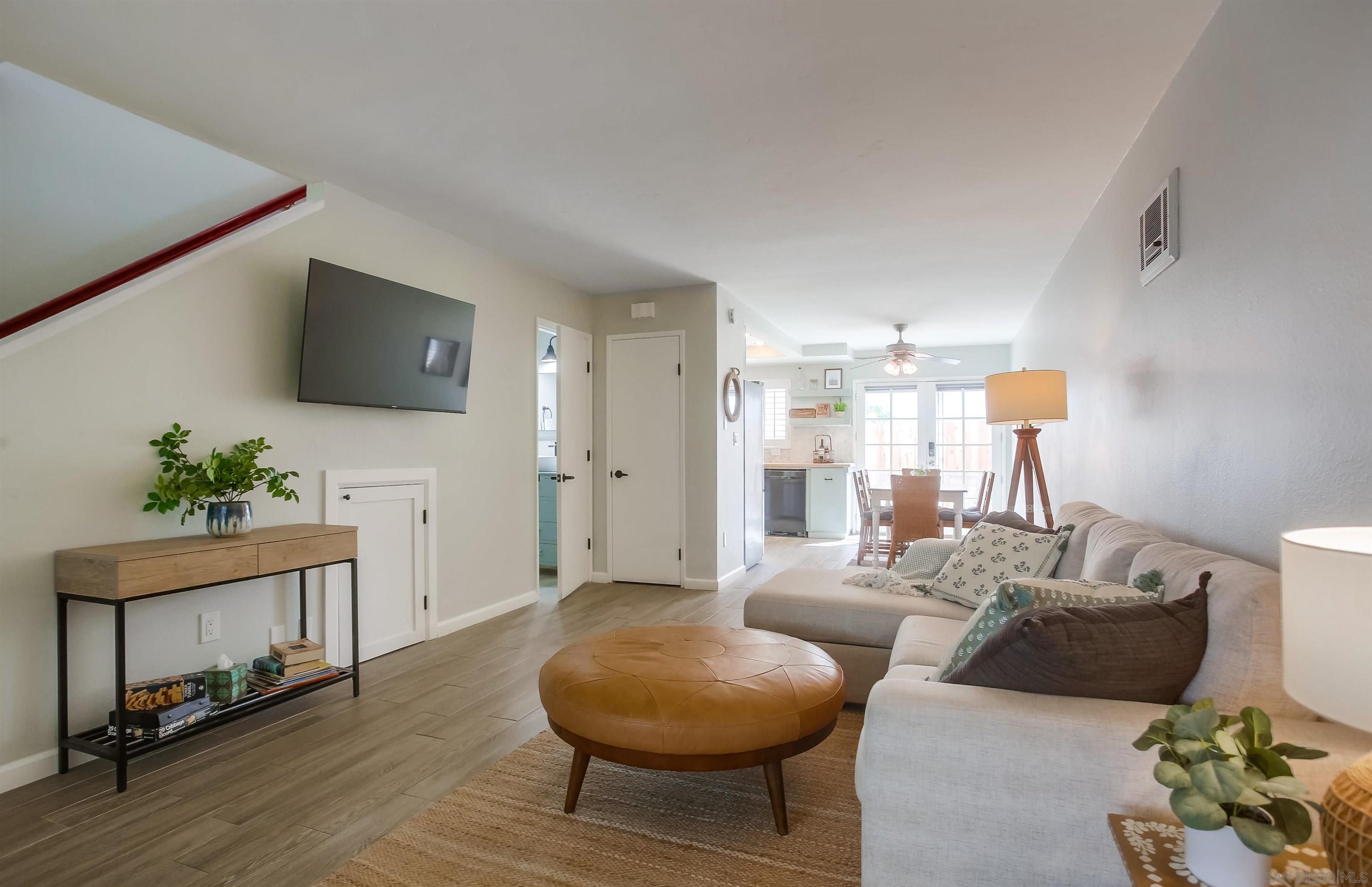 a living room with furniture and a potted plant