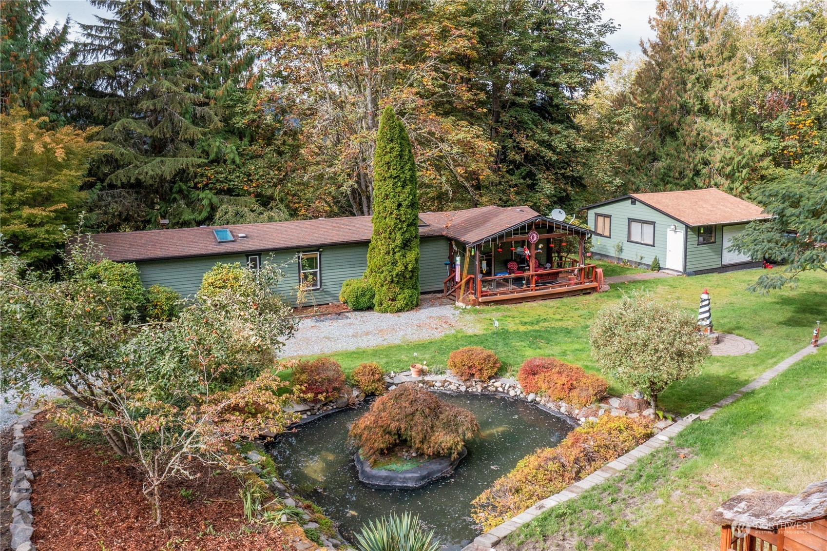 a view of a house with a yard and sitting area