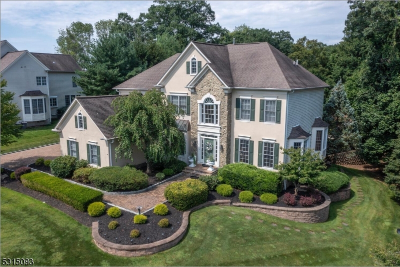 a aerial view of a house with yard and green space