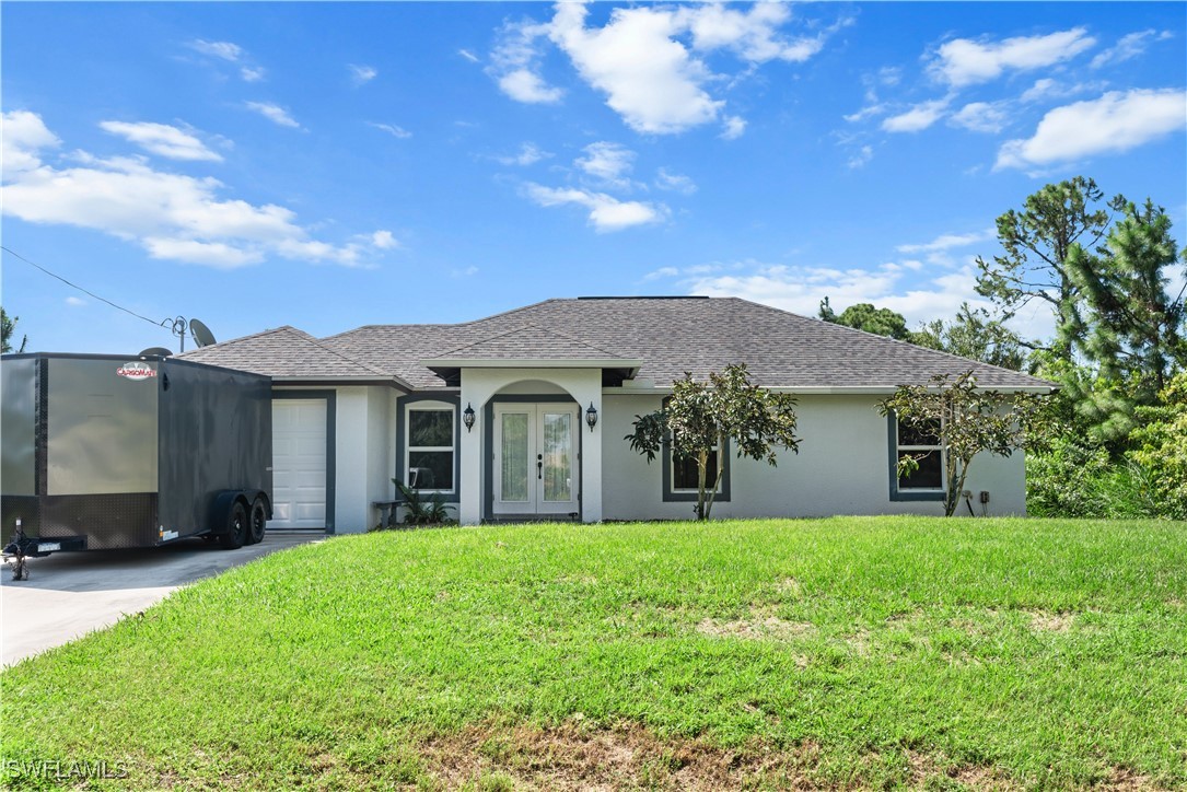 a front view of house with yard and green space