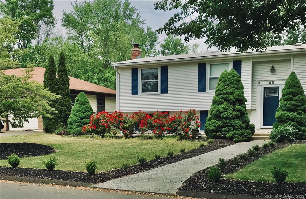 a front view of house with a garden