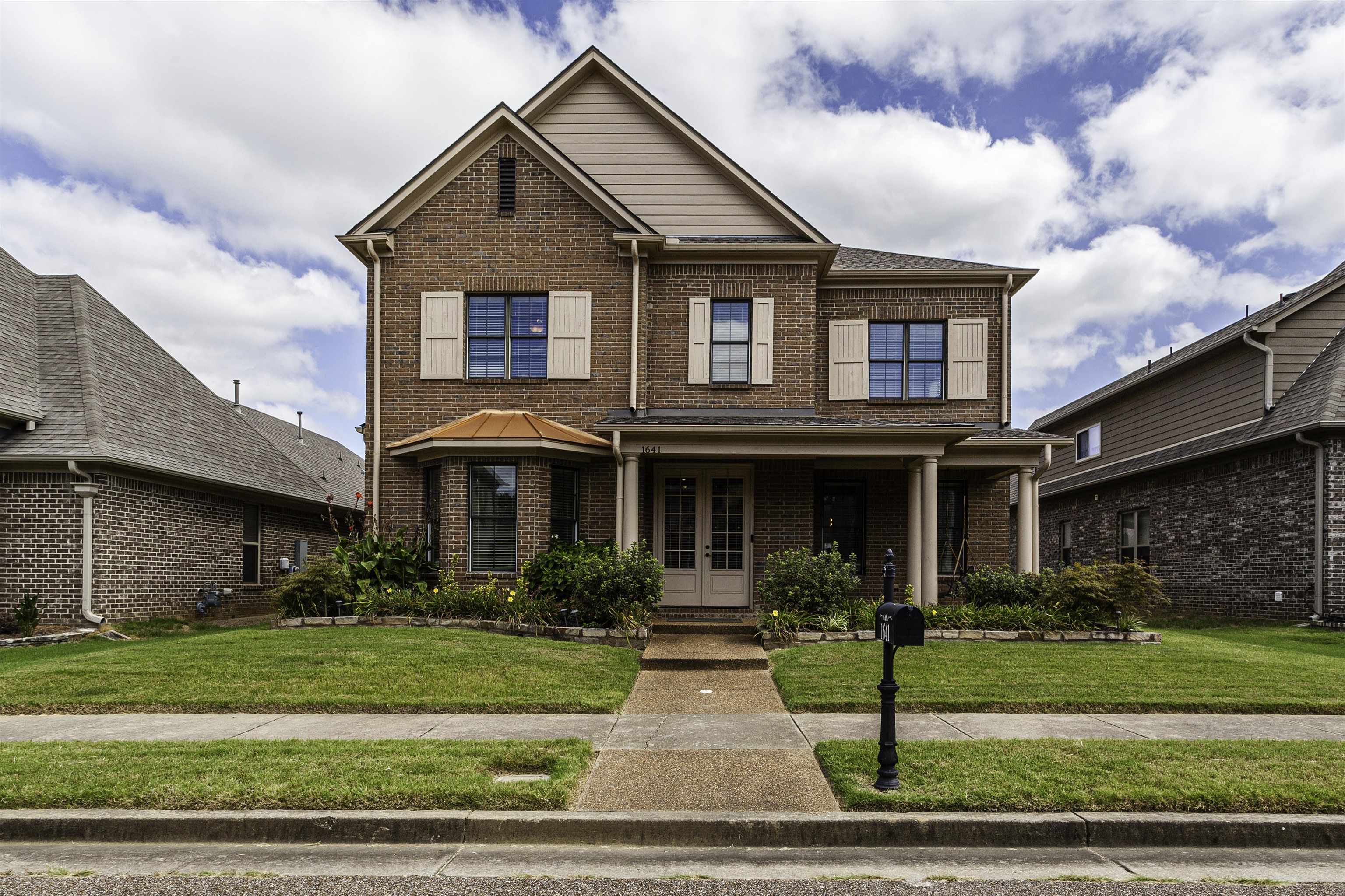 a front view of a house with a yard