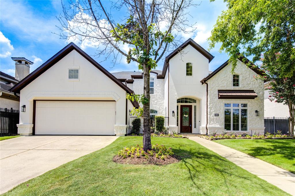 This sophisticated residence seamlessly blends warm modern design elements with functional elegance, capturing a curb appeal replete with refined landscaping and attached garage for secure parking.