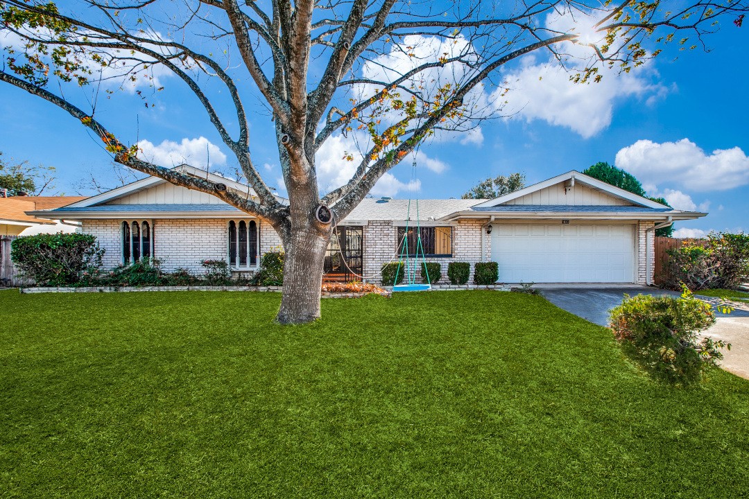 a front view of a house with a garden