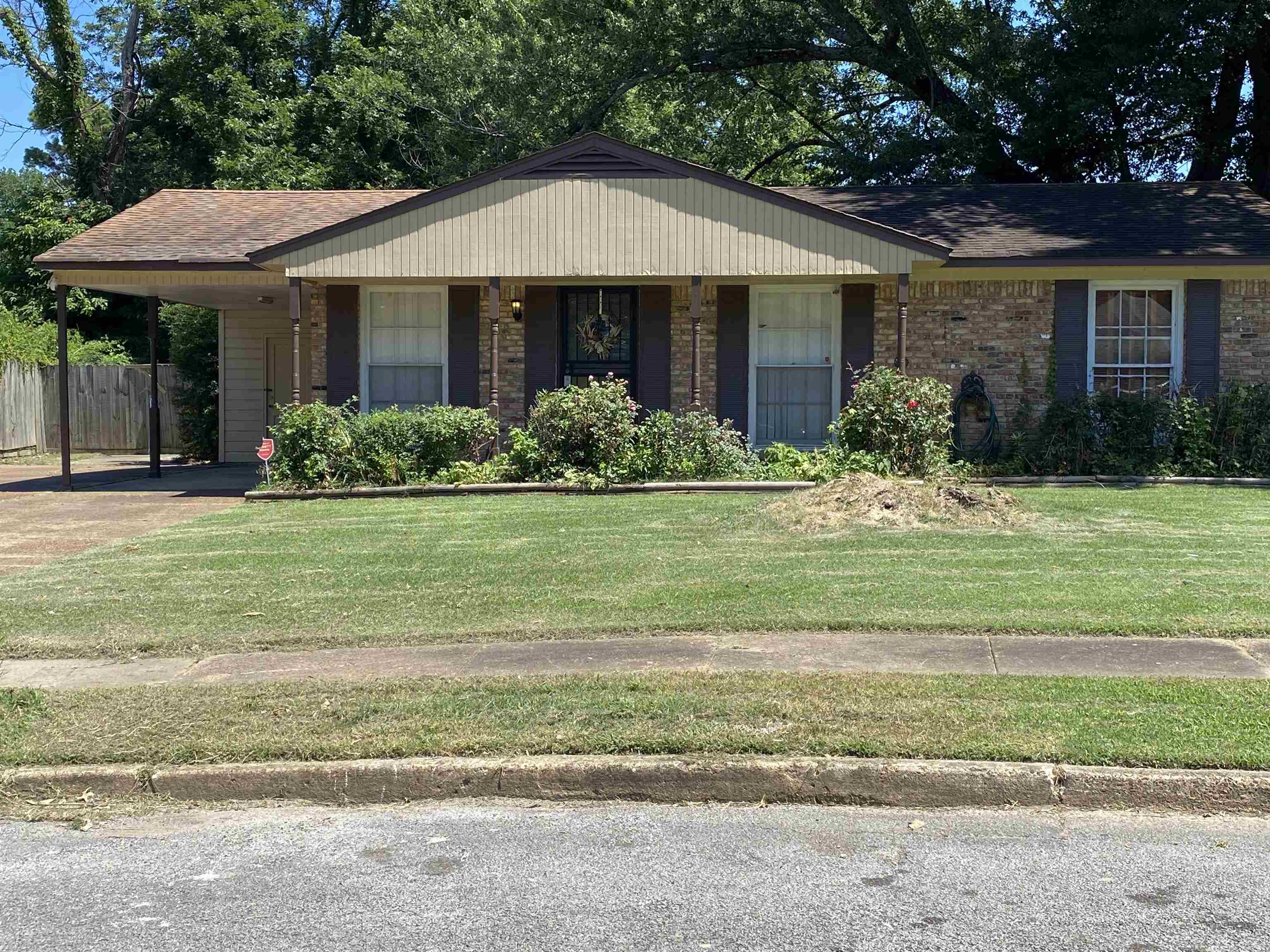 Ranch-style home featuring a front lawn