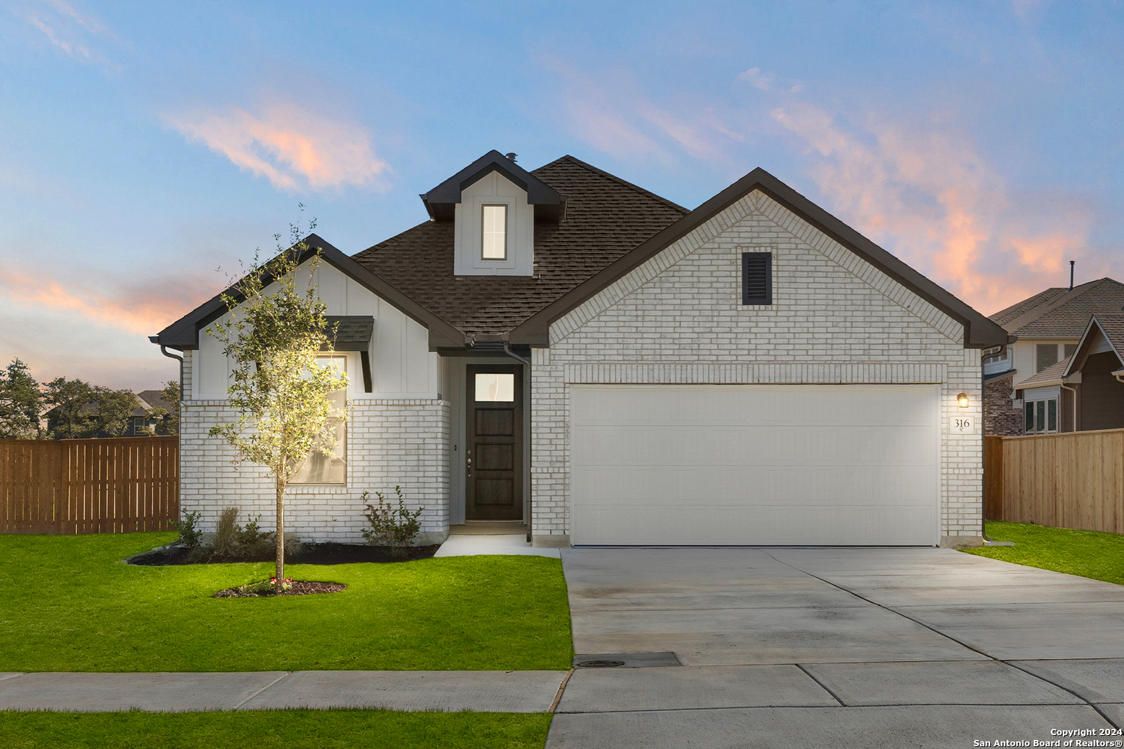 a front view of a house with a yard