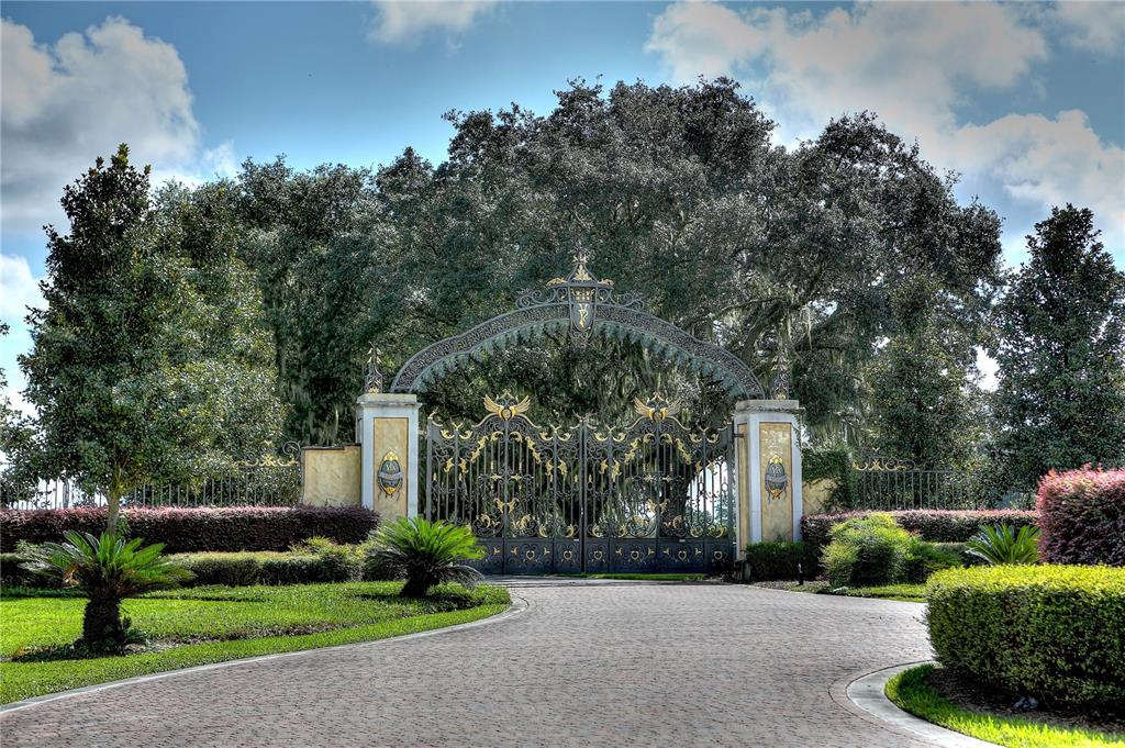 a front view of a house with a yard and a garden