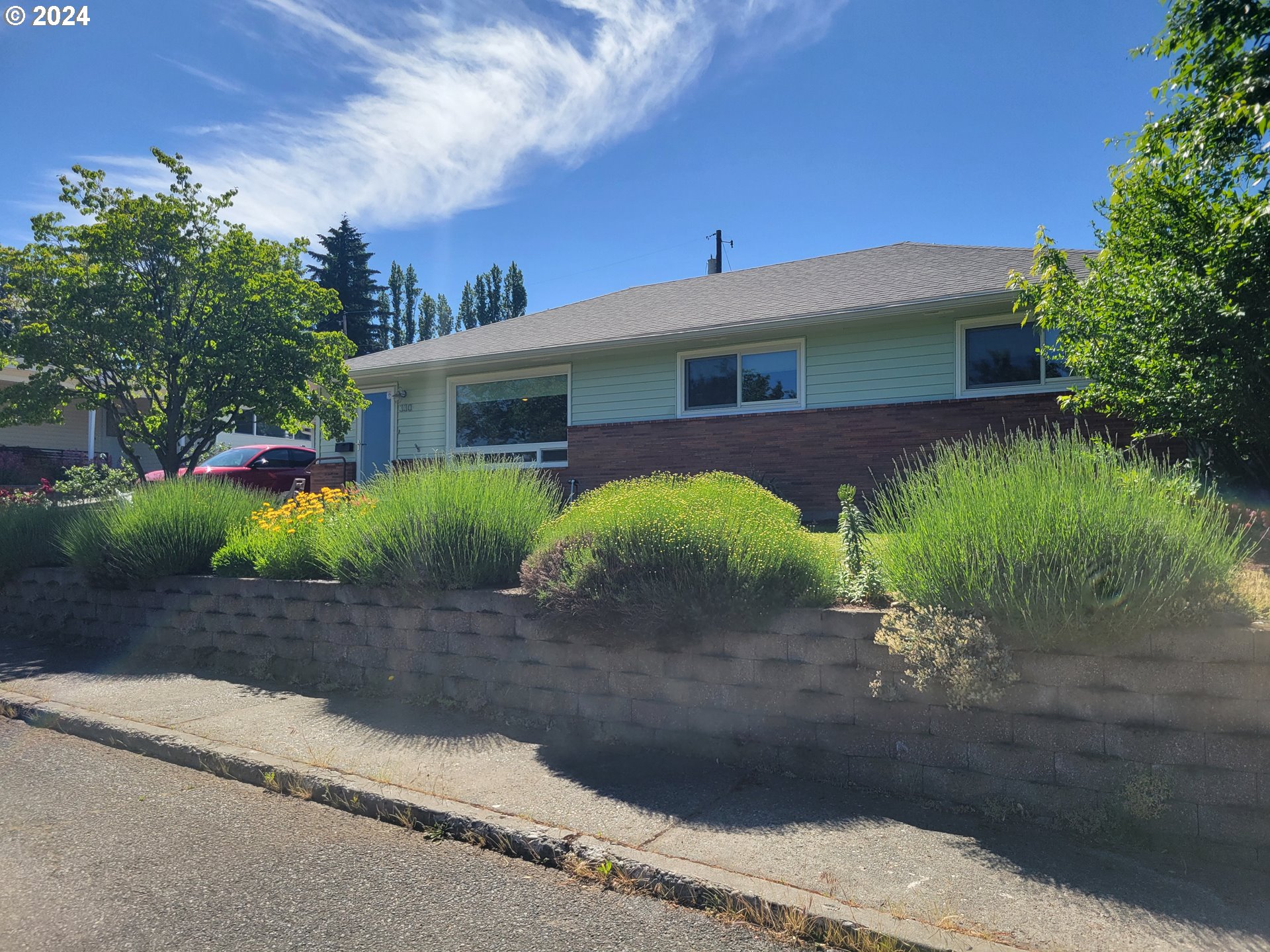 a front view of a house with garden