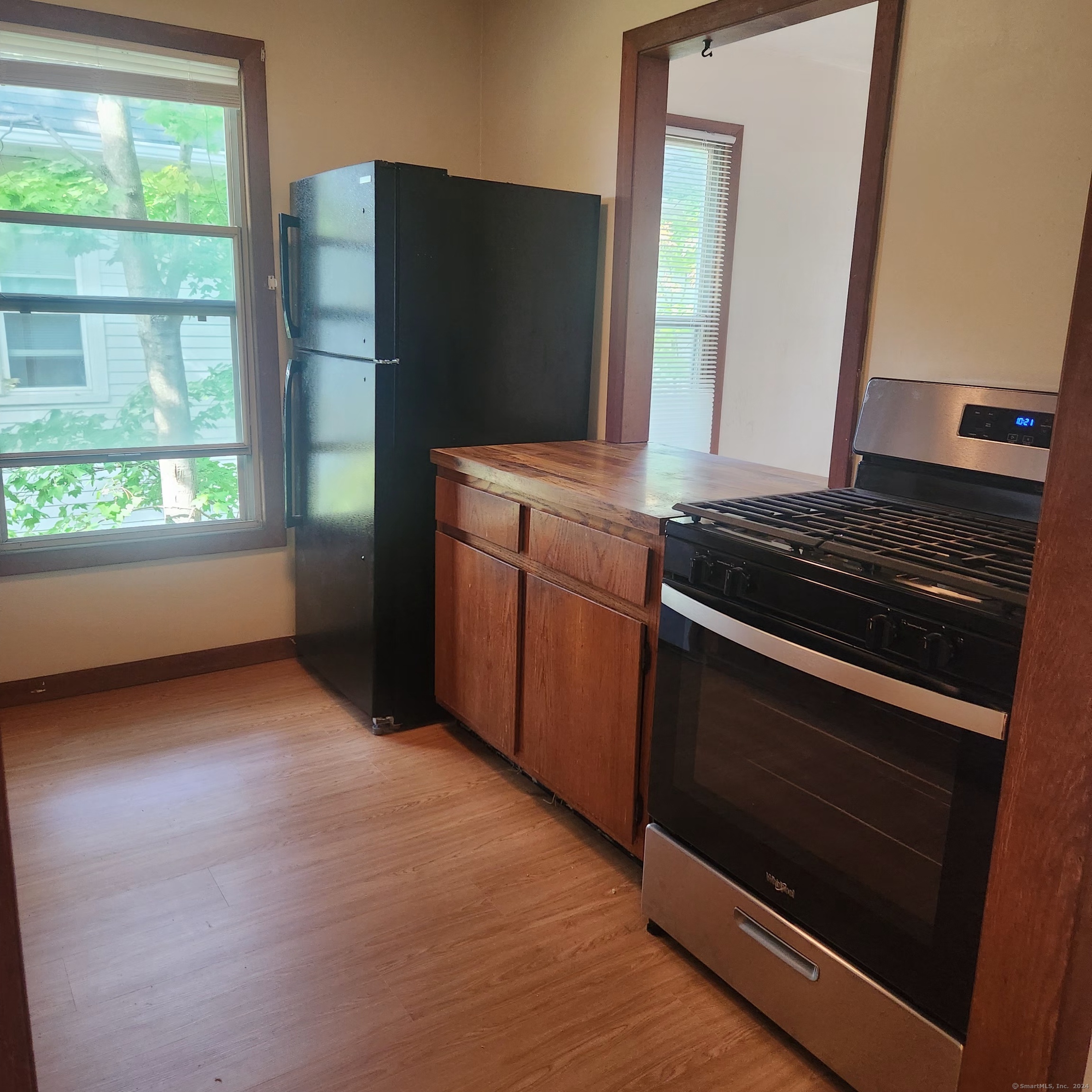 a kitchen with granite countertop a stove and a microwave