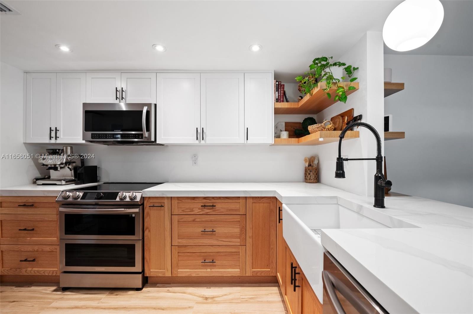 a kitchen with a sink a stove and a microwave