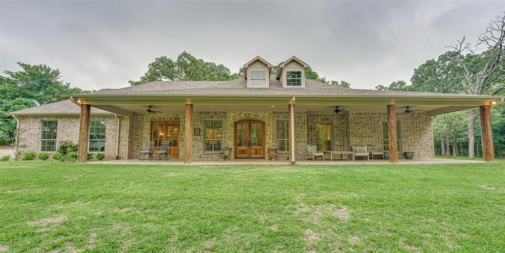 front view of a brick house with a yard