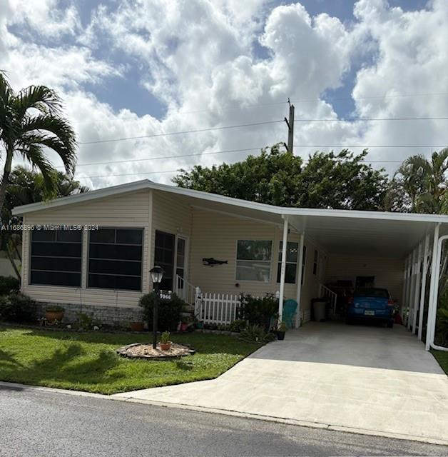 a view of house with garage and a garden