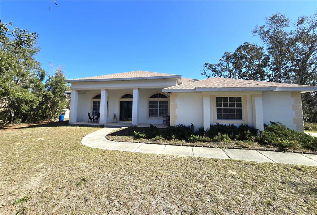 a front view of house with yard and green space