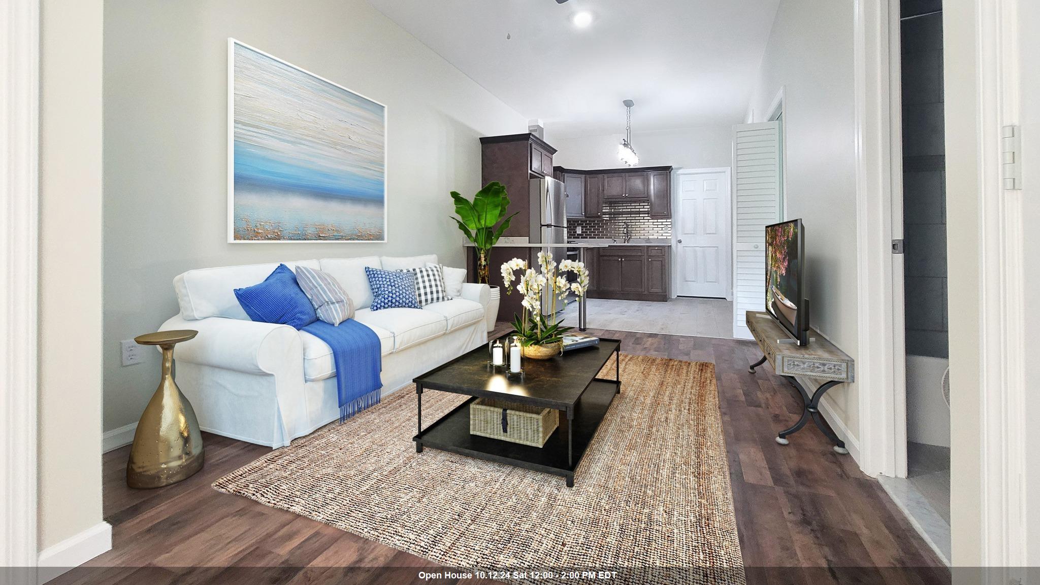 a living room with furniture and a wooden floor