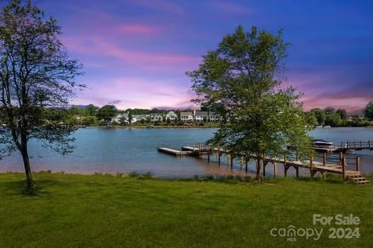 a lake view with a big yard