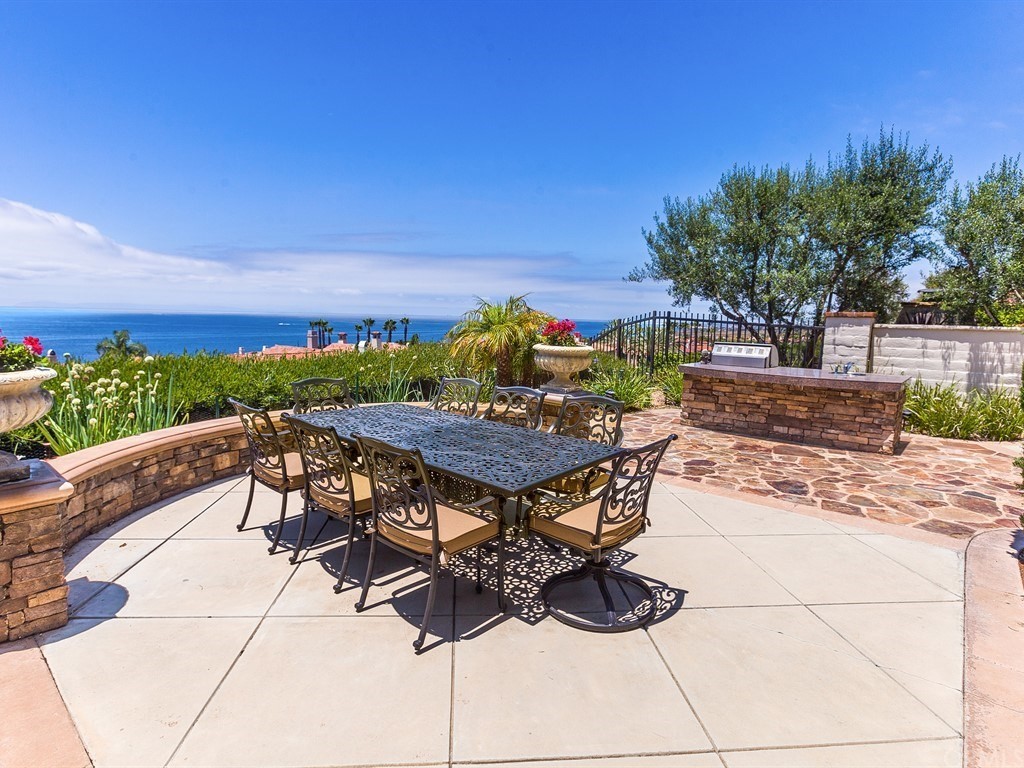 a view of a terrace with furniture and a yard