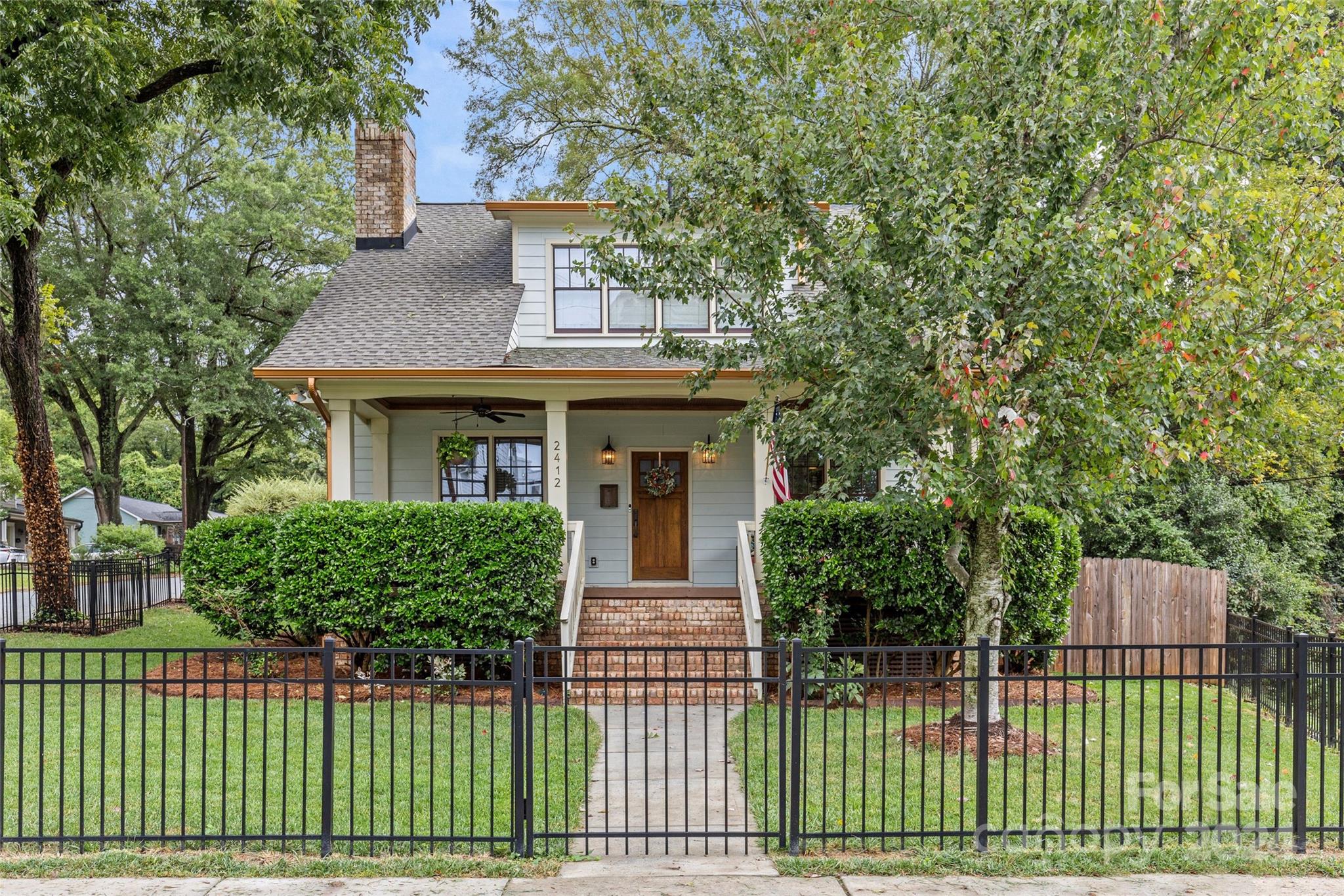 a front view of a house with a garden