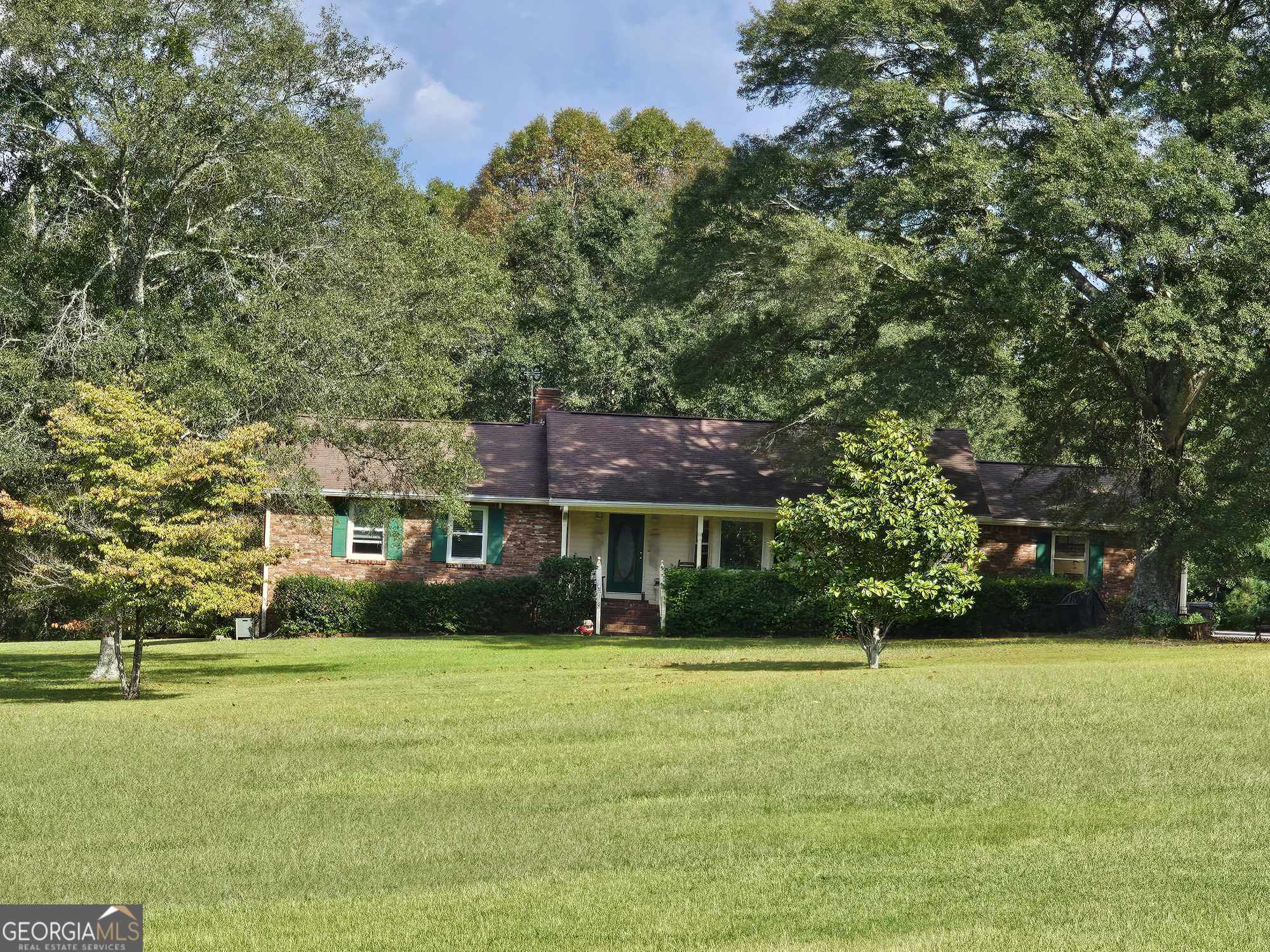 a front view of house with yard and green space