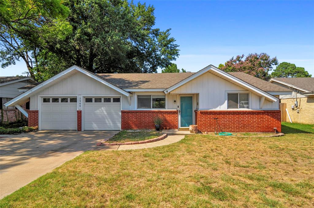 a view of a house with a yard and garage