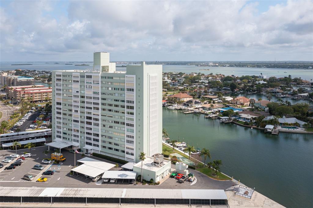 a view of a lake with a barbeque and tall buildings